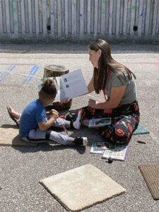 An Inspiring Minds volunteer helps a child
